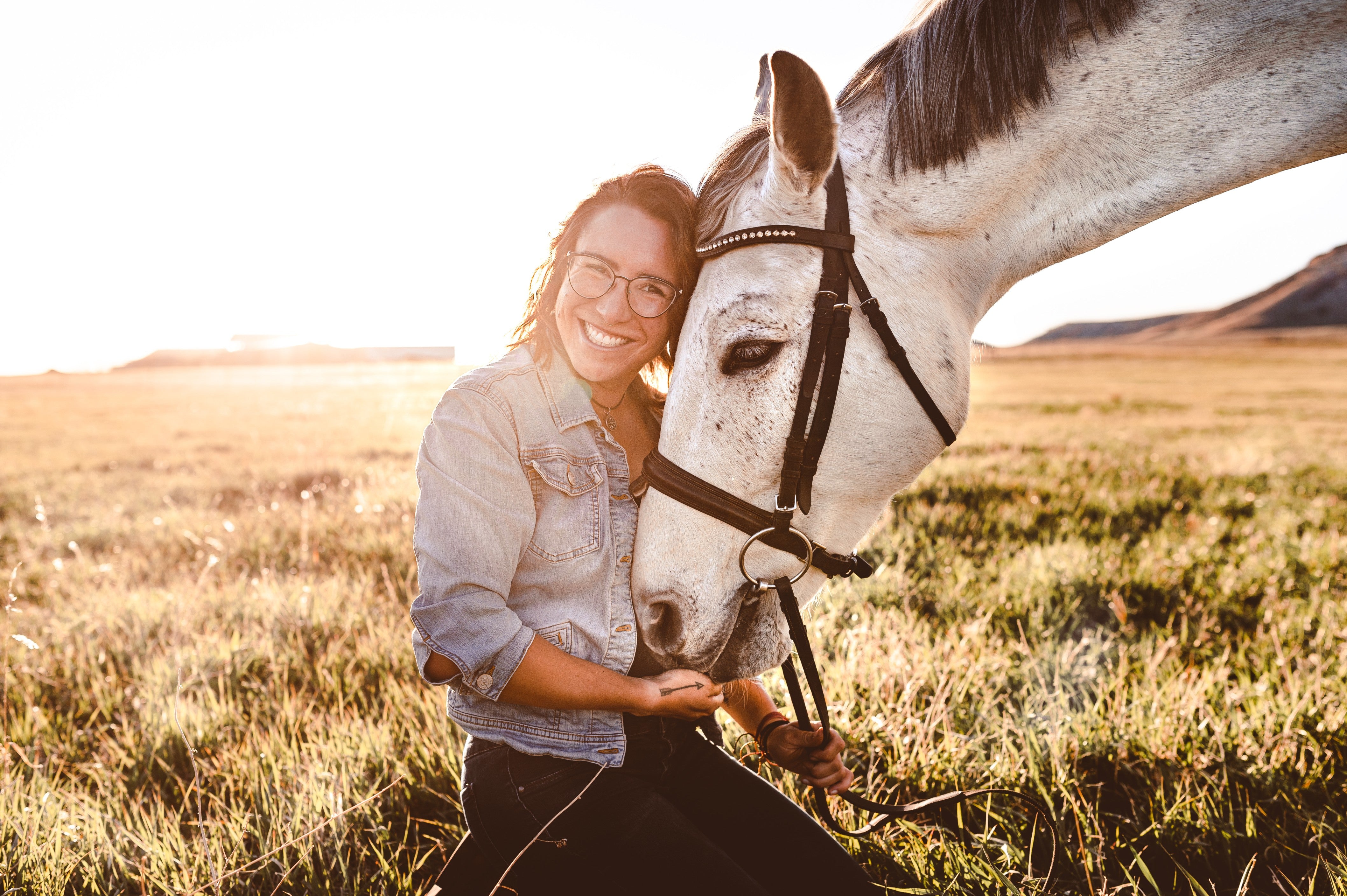 horse and rider in field with sun shining and lots of smiles