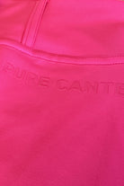 Close-up image of a bright pink performance fabric with stitching details. The words "Pure Canter" are embossed onto the fabric, appearing slightly raised and subtly visible due to the similar color, capturing the essence of equestrian fashion in the V2 Fusion Riding Tights - Hot Pink by Pure Canter.